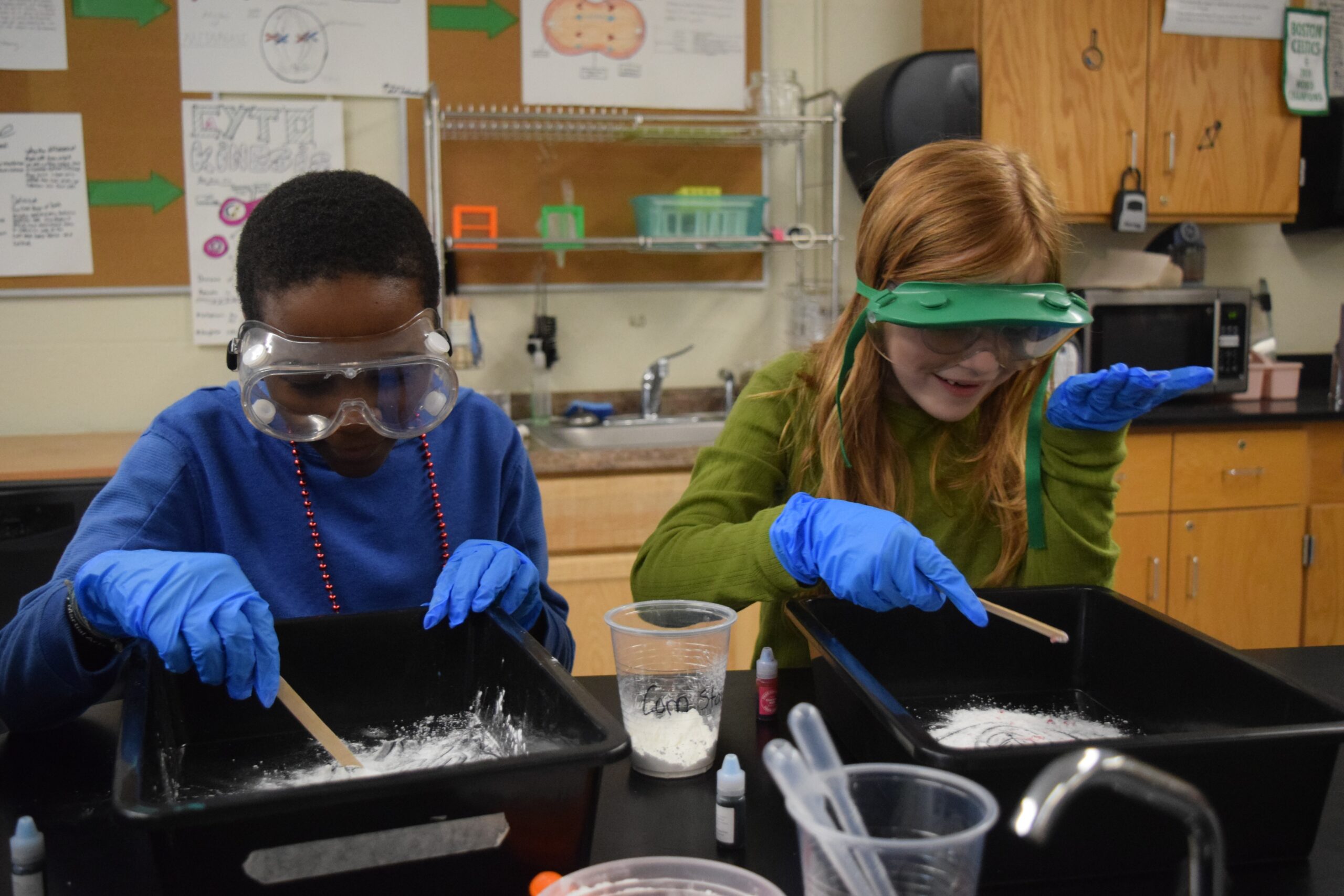 two students with goggles and gloves