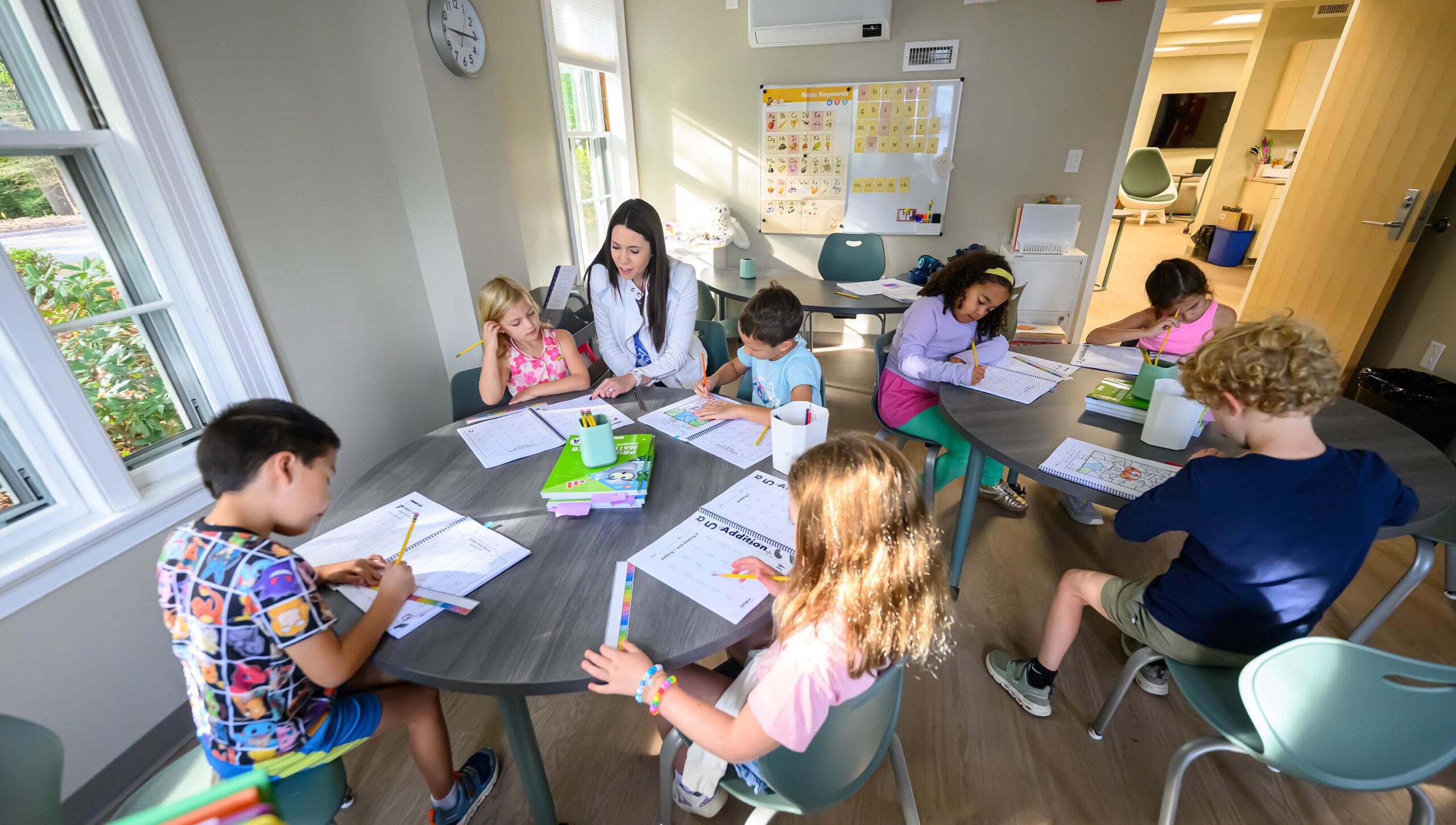 students working in groups at tables